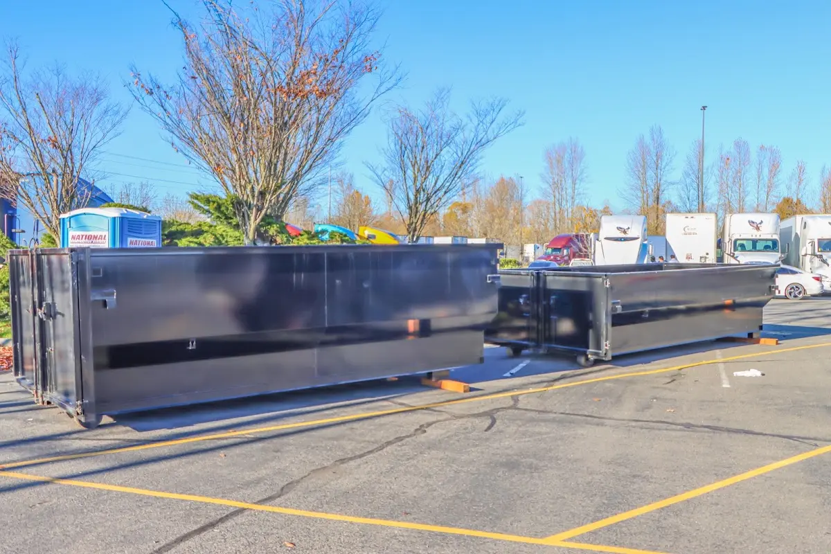 Professional dumpster rental service with roll-off container on residential driveway in Summerville